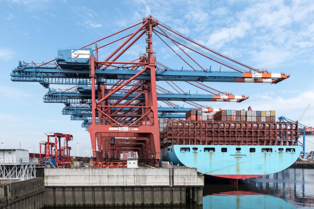 Cranes and shipping containers at a port, illustrating India-UAE CEPA hospitality linen trade