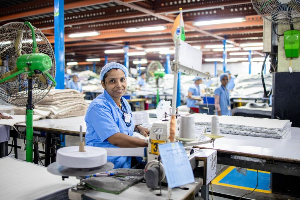 Textile worker inspecting hospitality linen