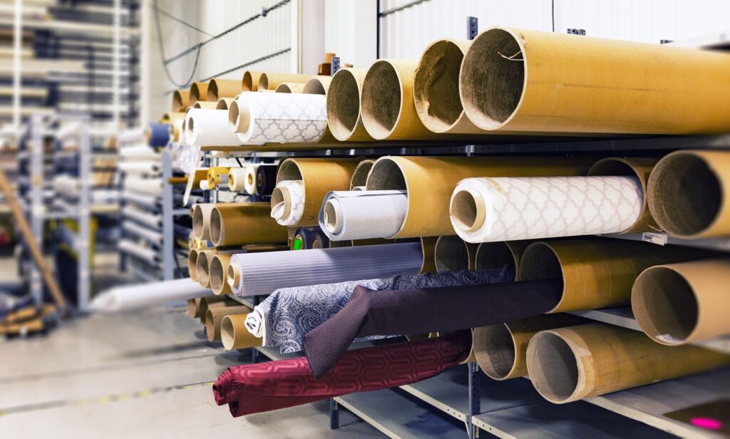 Rows of textile rolls stored in a factory warehouse